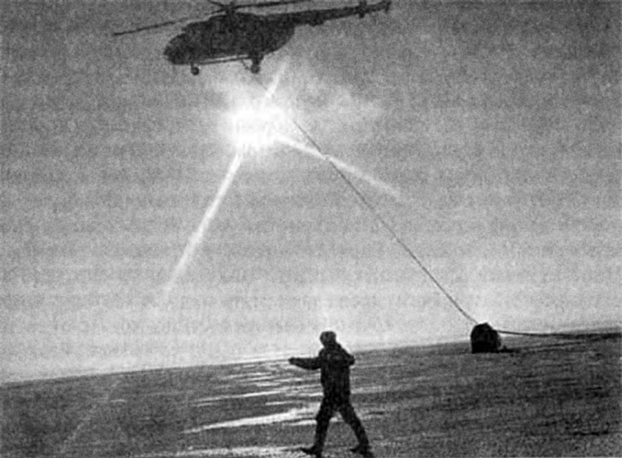Towing the device with a parachute by helicopter