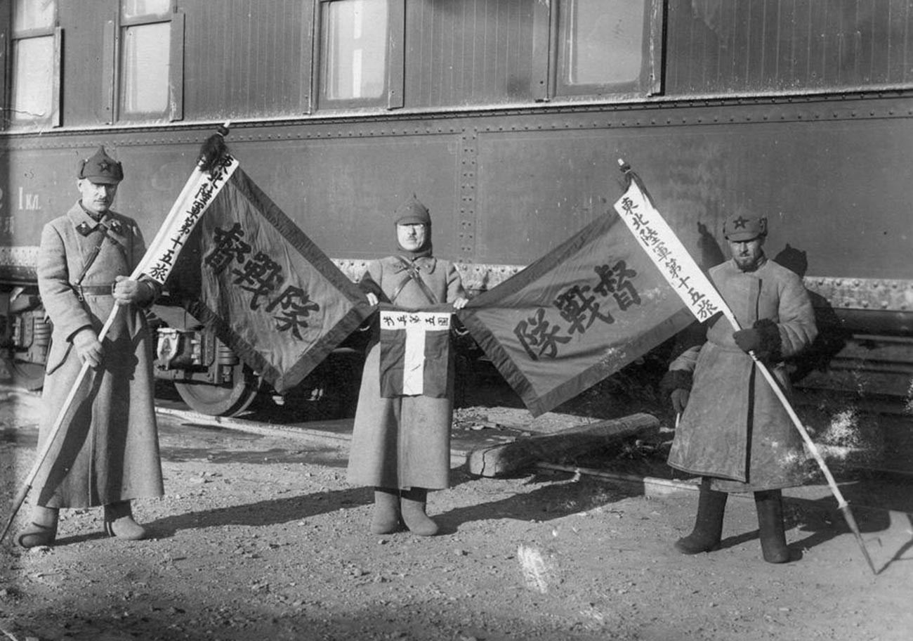 Soviet soldiers with captured Kuomintang flags.