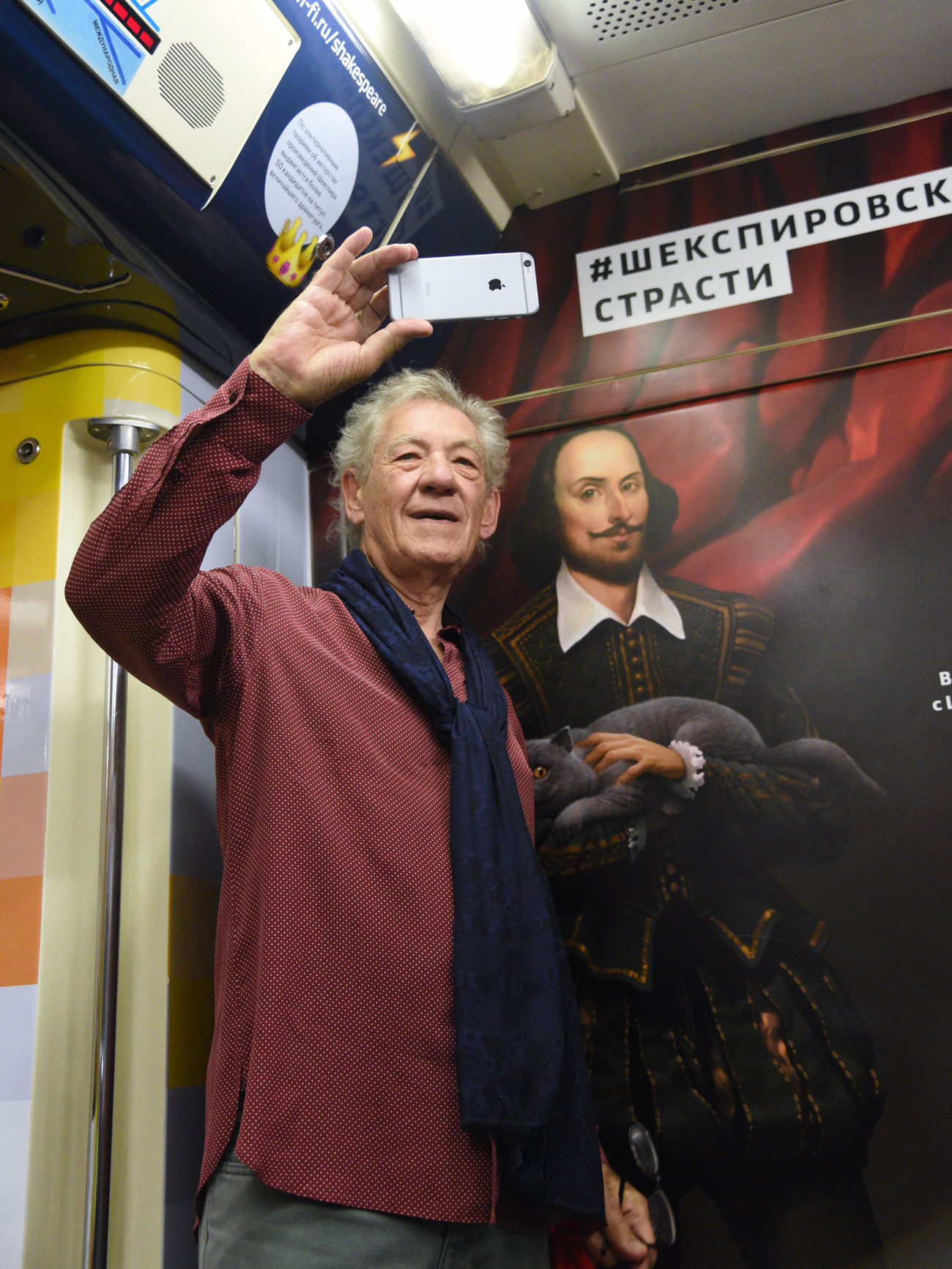 Ian McKellen rides Shakespeare train in Moscow metro.
