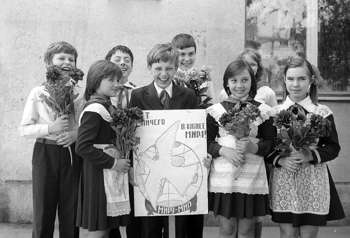 A group of children holding a placard that says 