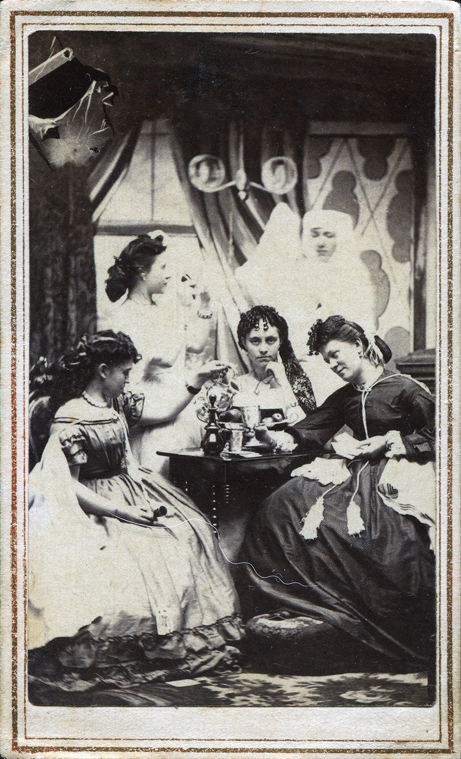 A group of young women meeting in a parlor. A ghostly figure is pictured in the background, Lowville, New York, circa 1860