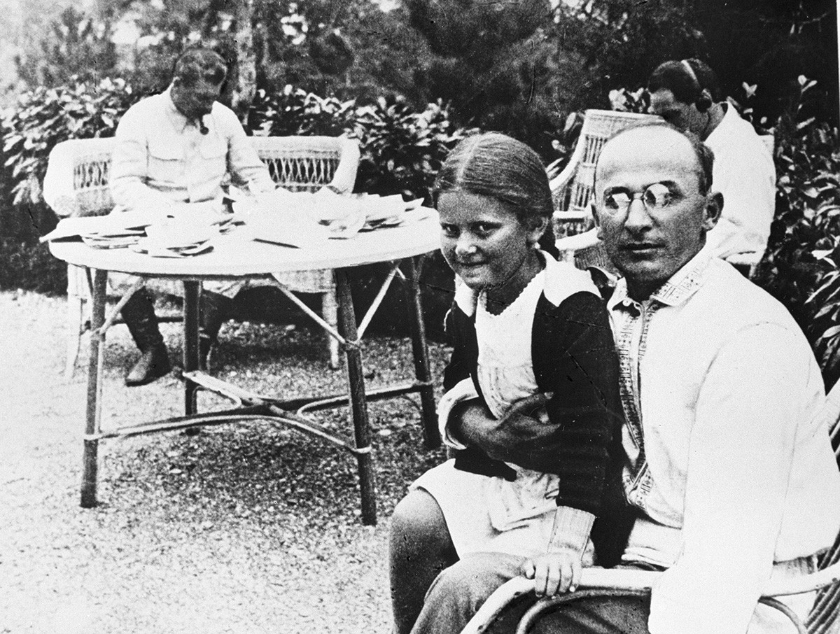 Joseph Stalin and Lavrenty Beria and Stalin's daughter Svetlana on his lap