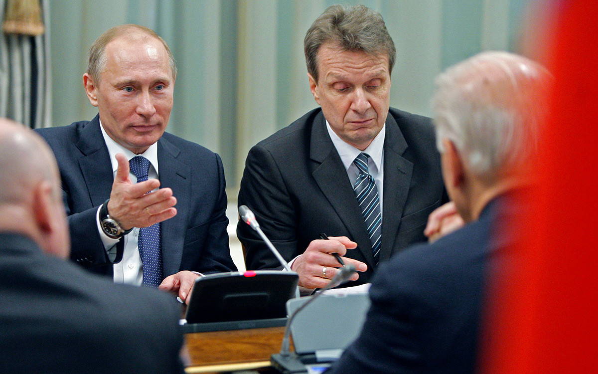 Vice President of the United States Joe Biden, right with back to camera, listens to Russian Prime Minister Vladimir Putin, left, in Moscow, Russia, Thursday, March 10, 2011.
