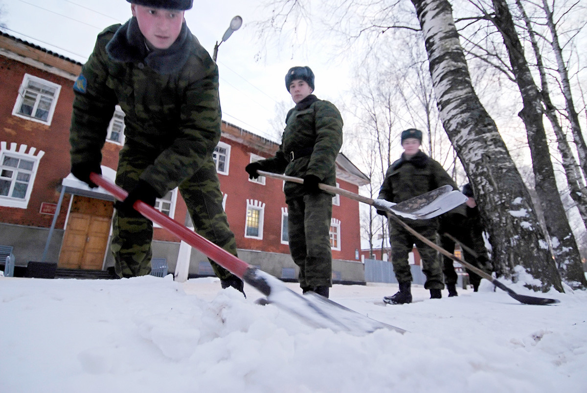 Des militaires déneigeant dans le village de Novosselitsy, dans la région de Novgorod