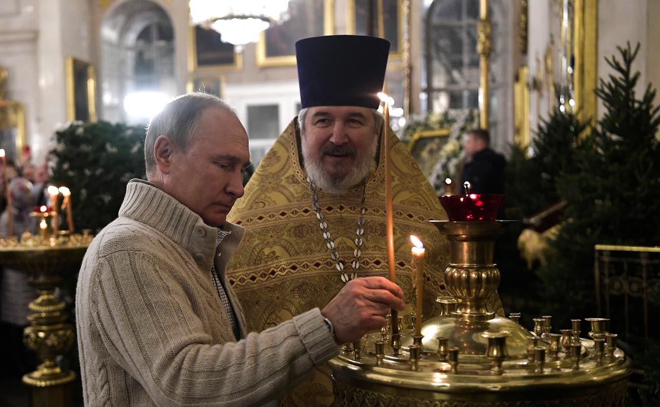 Vladimir Putin menghadiri kebaktian di Katedral Transfigurasi Sankt Peterburg bersama Kepala Katedral Nikolai Bryndinpada malam Natal.