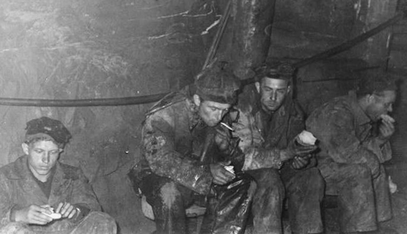Political prisoners on a break inside a mine in a Far East camp