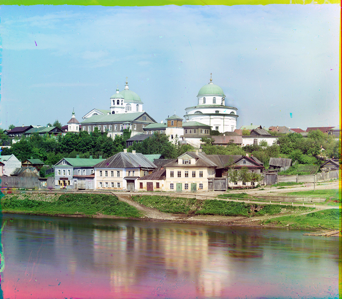 Torzhok. View east from Novgorod Embankment across Tvertsa River. Top: Resurrection Convent with Resurrection Cathedral (left) & Church of Decapitation of John the Baptist. Summer 1910