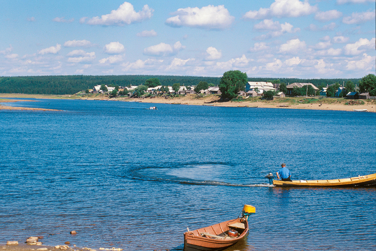 View across Varzuga River toward left bank. Wooden skiffs serve as ferries. July 21, 2001