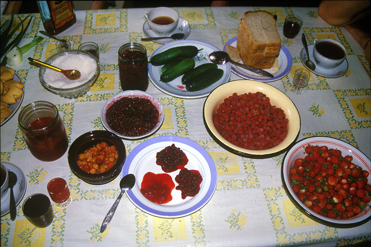 Kimzha. Kitchen table at Lidia Ivanovna's house. Forest berries, garden produce, jams, preserves, kisel, mors--all gathered & produced by Lidia Ivanovna & friends. August 2, 2000