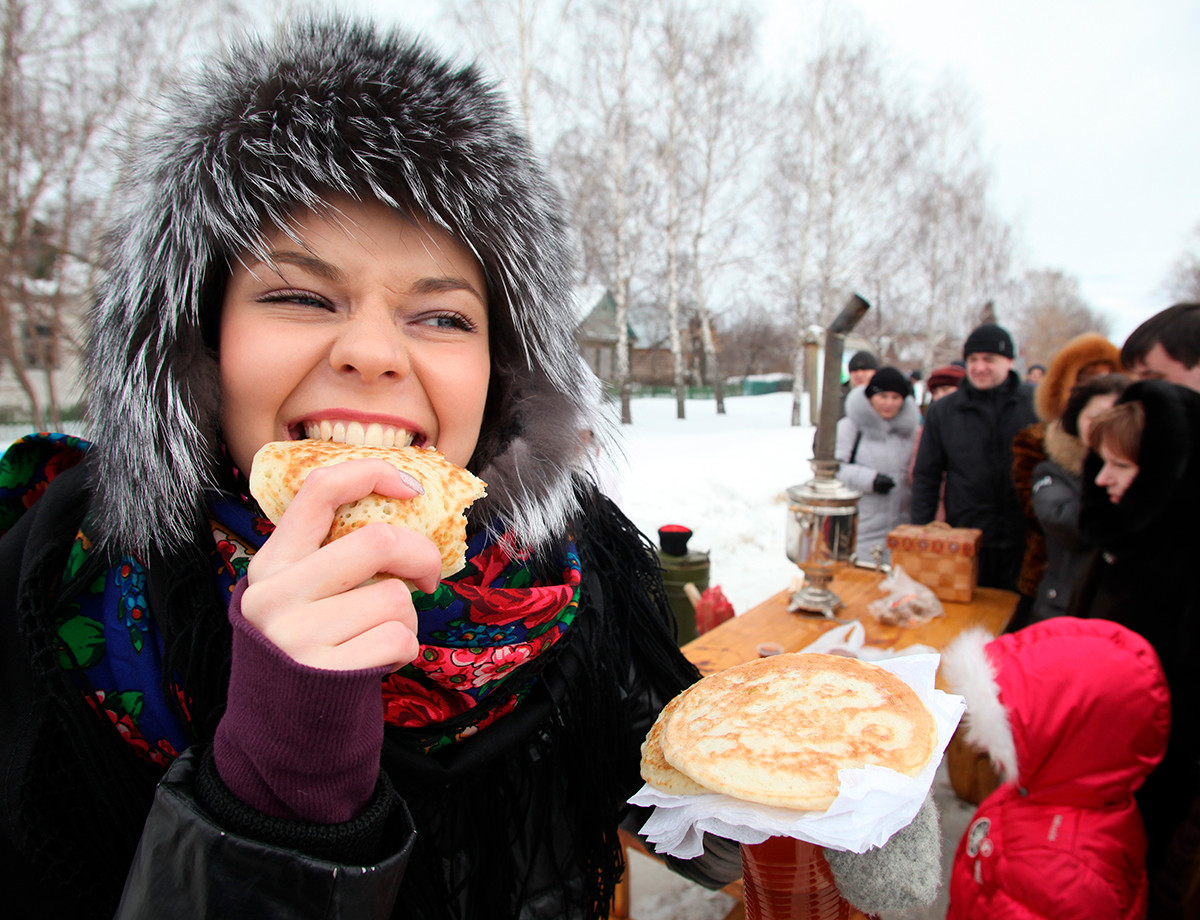 Une fille dégustant une crêpe lors des célébrations de la Maslenitsa (Mardi Gras russe) dans la ville de Riazan
