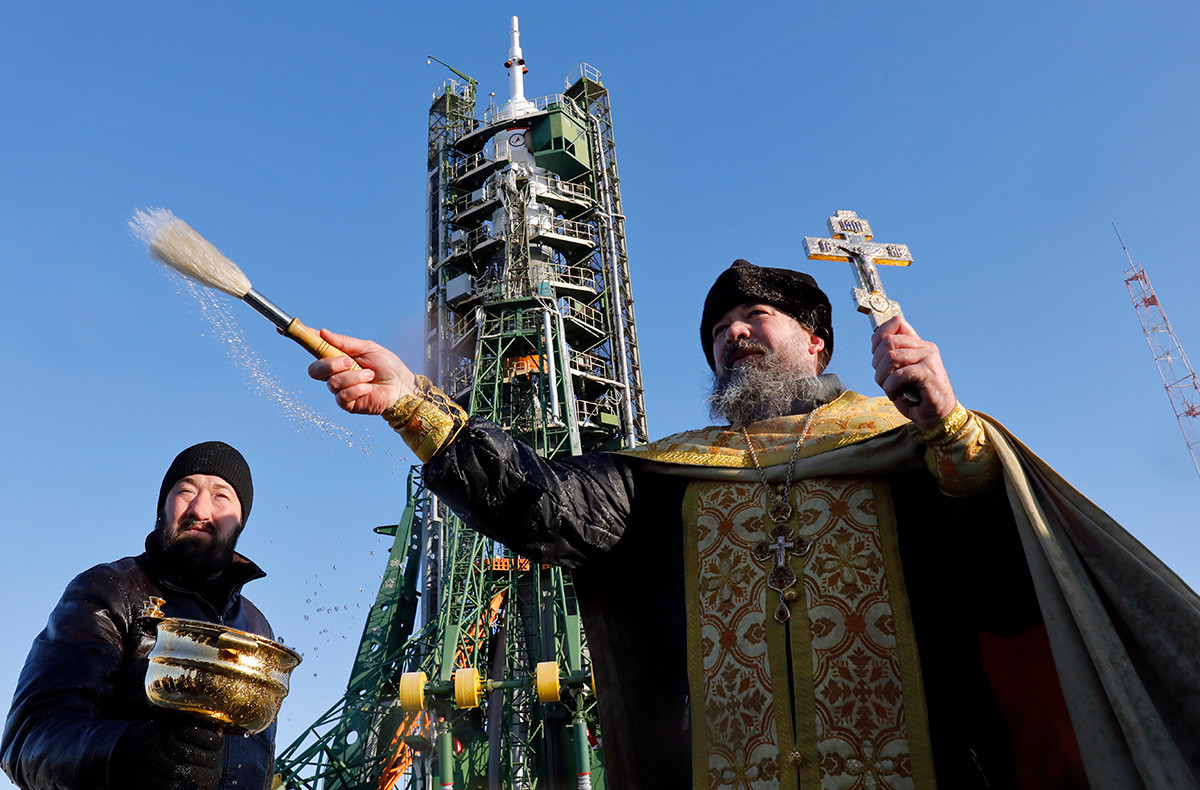 An Orthodox priest conducts a blessing service in front of the Soyuz FG rocket at the Russian leased Baikonur cosmodrome, Kazakhstan.