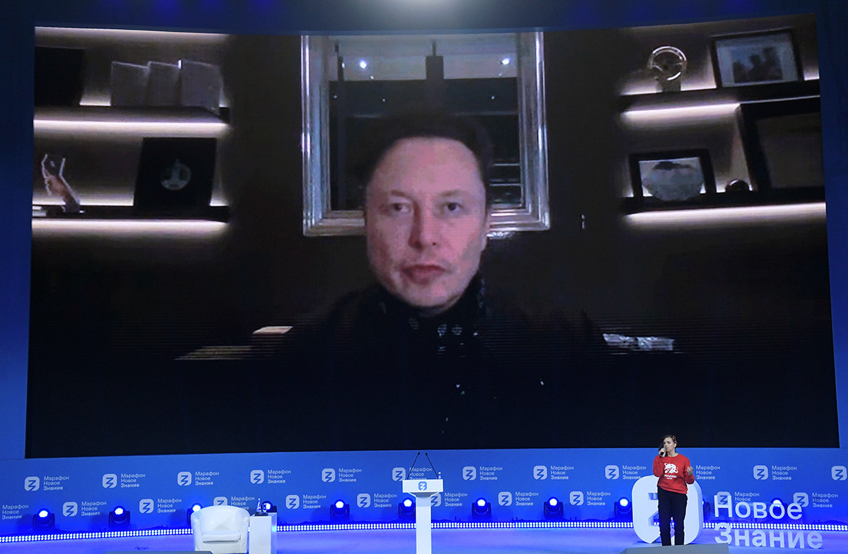 Elon Musk speaks at the forum via a video call.