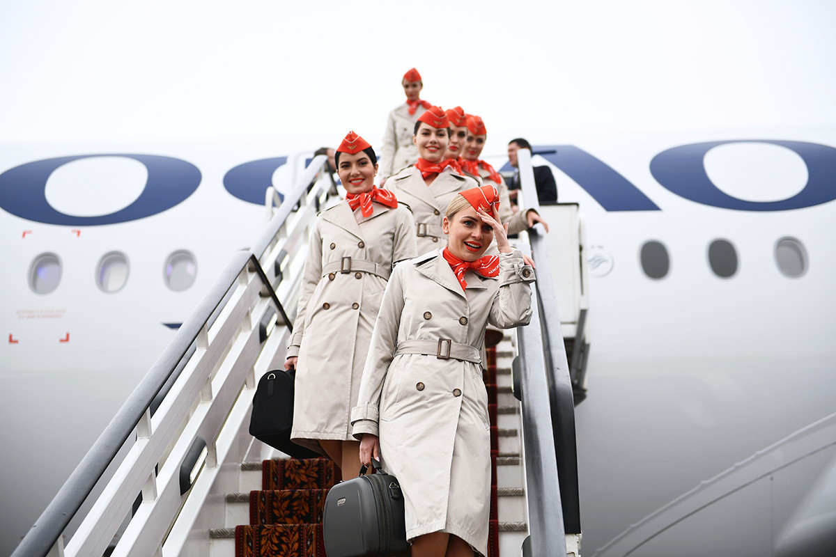 Flight attendants go down the stairs of an Airbus A350-900 long-range wide-body passenger aircraft of the Aeroflot airline at the Sheremetyevo international airport named after Alexander Pushkin in Moscow