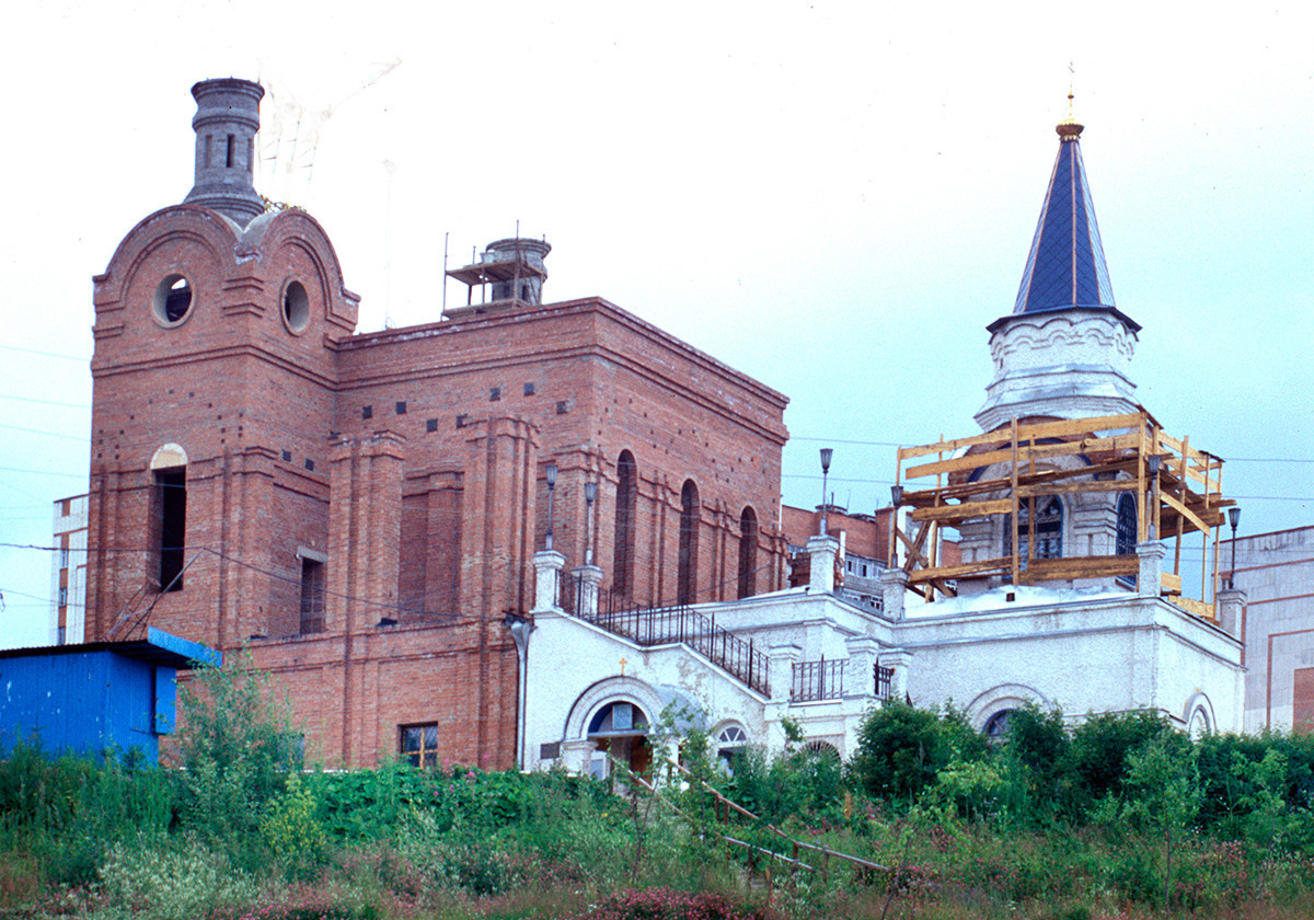 Iglesia de la Intercesión de la Virgen (derecha), vista sureste. Construida en 2001-03 como bautisterio para la Catedral de San Serafín de Sarov (en construcción a la izquierda). 16 de julio de 2003.