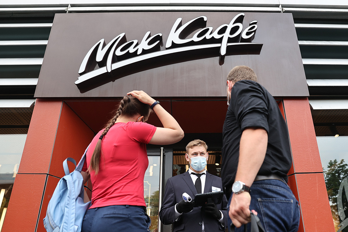 People wait outside a McDonald's fast food restaurant in Bolshaya Bronnaya Street, central Moscow. As of June 28, 2021, McDonald's introduces a contactless system for takeaway orders and starts serving customers who have a QR-code.