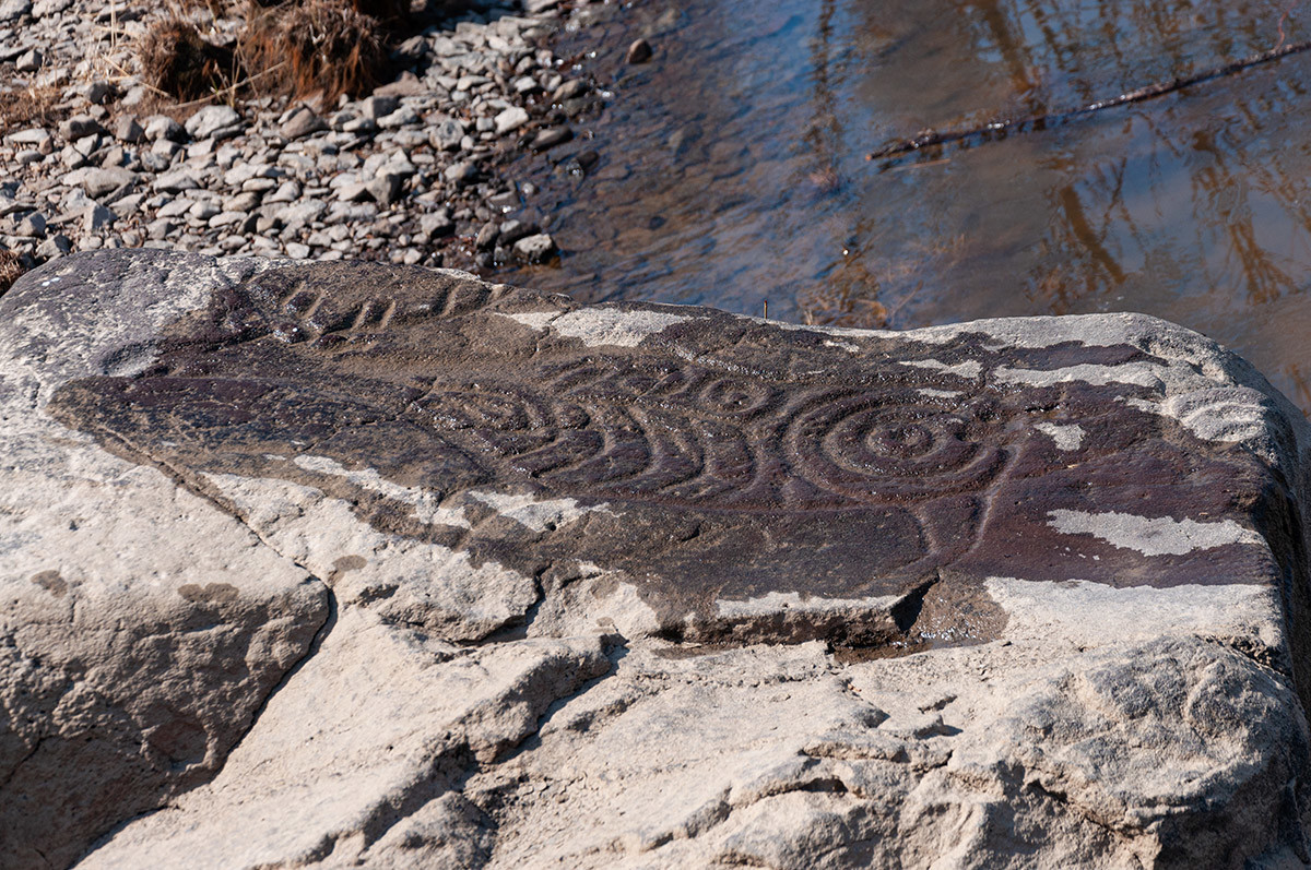 Petroglyphs on the stones on the bank of Amur river