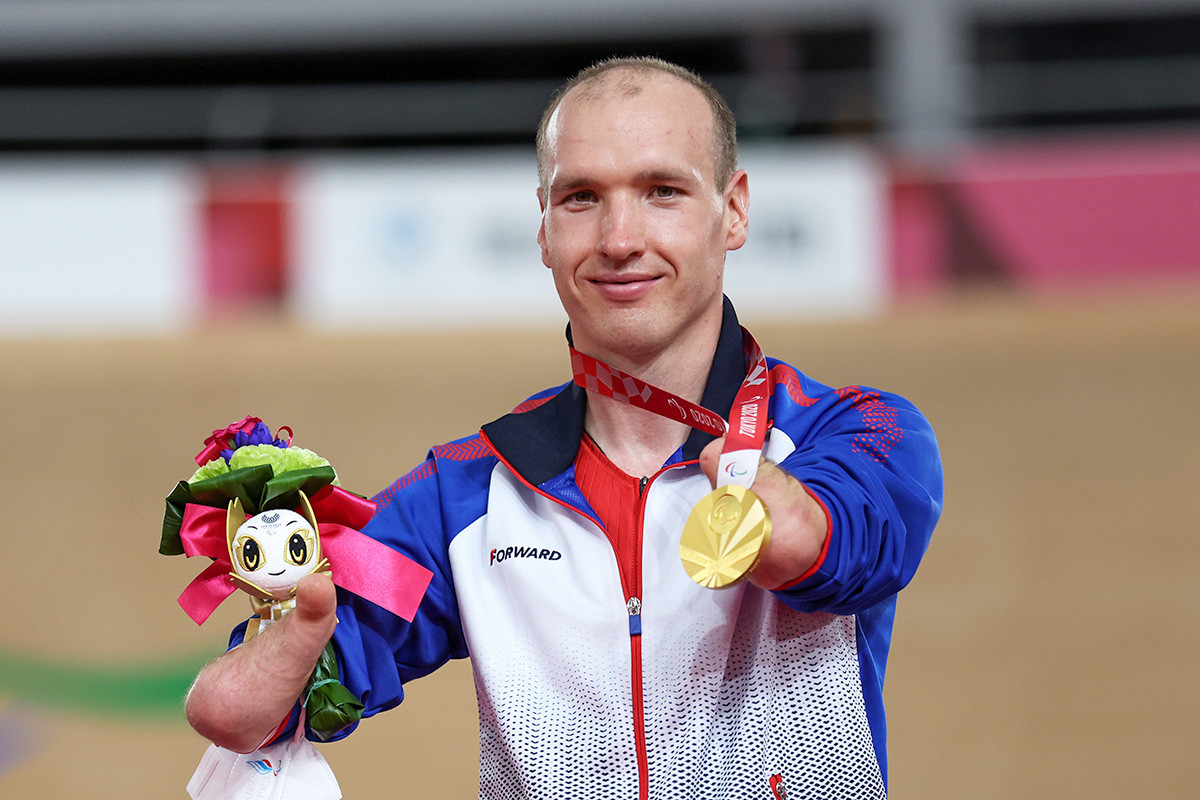 Gold medalist Mikhail Astashov of Team RPC celebrates on the podium during the medal ceremony for the Track Cycling Men's C1 3000m Individual Pursuit Final on day 2 of the Tokyo 2020 Paralympic Games at Izu Velodrome on August 26, 2021 in Izu, Shizuoka, Japan