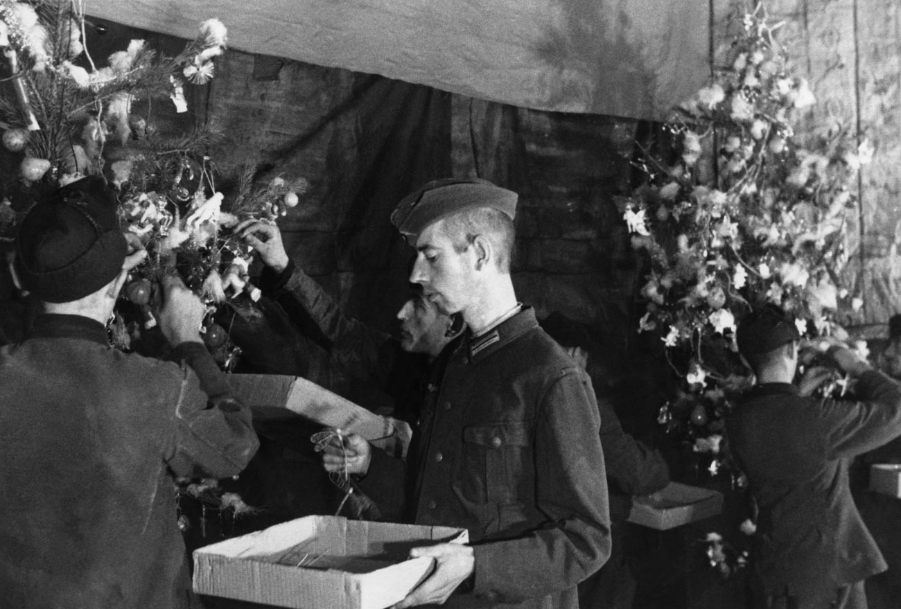 A propaganda shot from a Soviet POW camp, 1944. Captured German soldiers decorate the Christmas tree in the camp club.