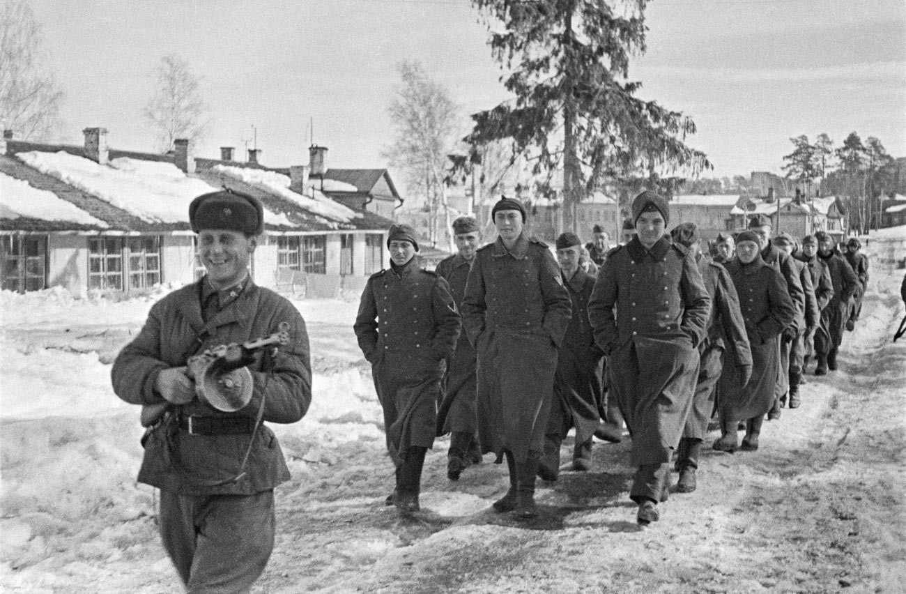 December 1941, Moscow region. Soviet soldiers convoy a column of captured German soldiers.