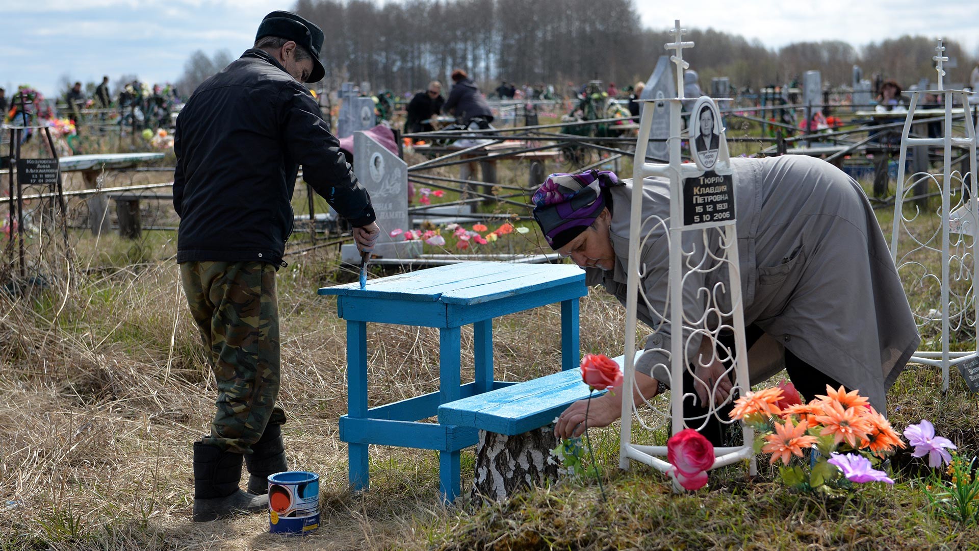 Russian people working in the cemetery in Omsk Oblast, Russia, during Radonitsa, a commemoration holiday.