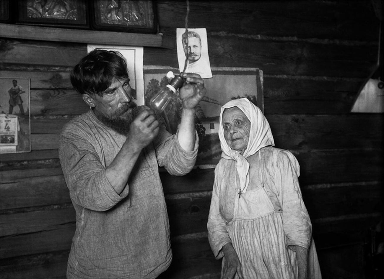 Peasants examining a light bulb