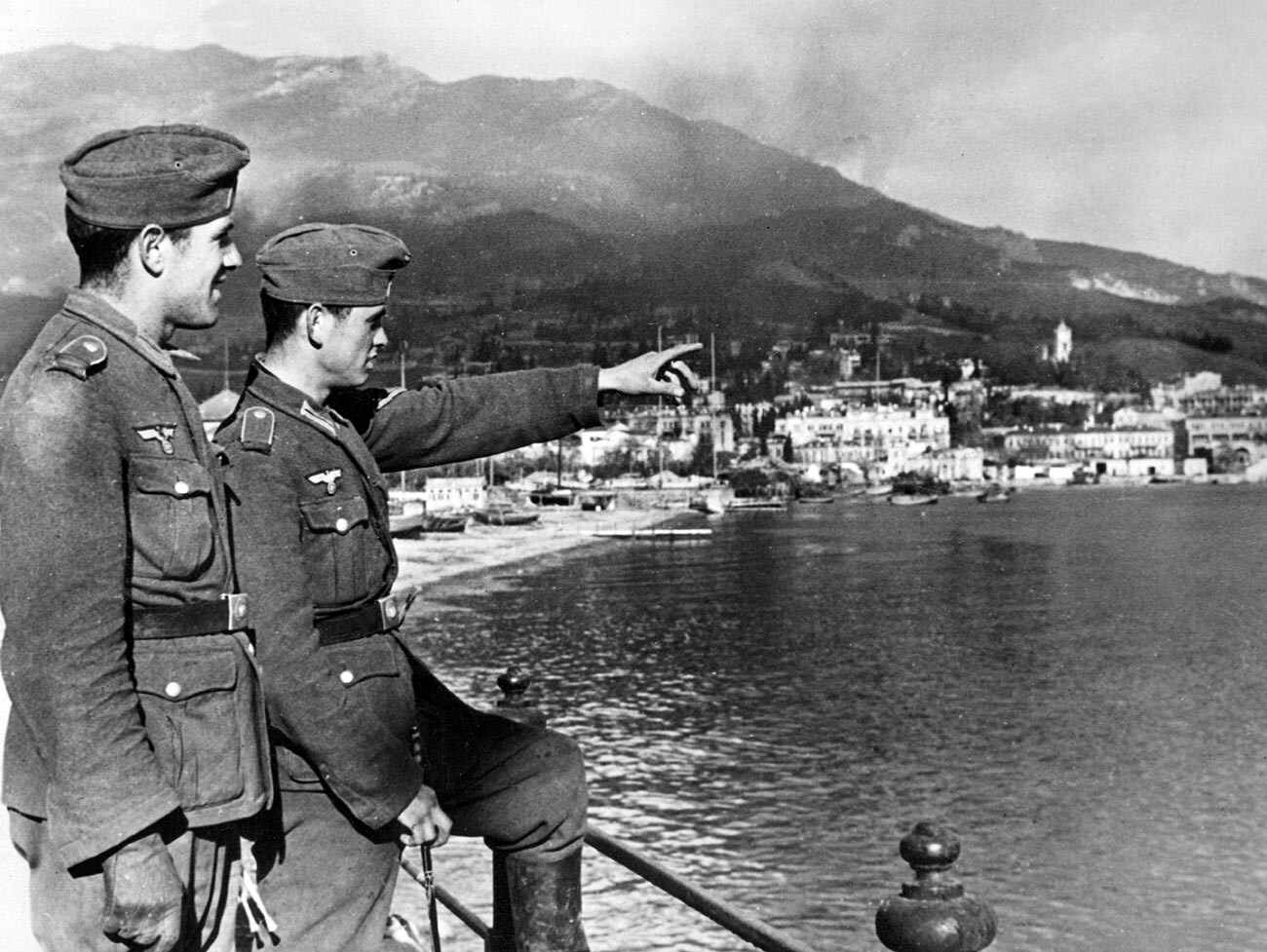 Two German army soldiers observe from a vantage point the city of Yalta.