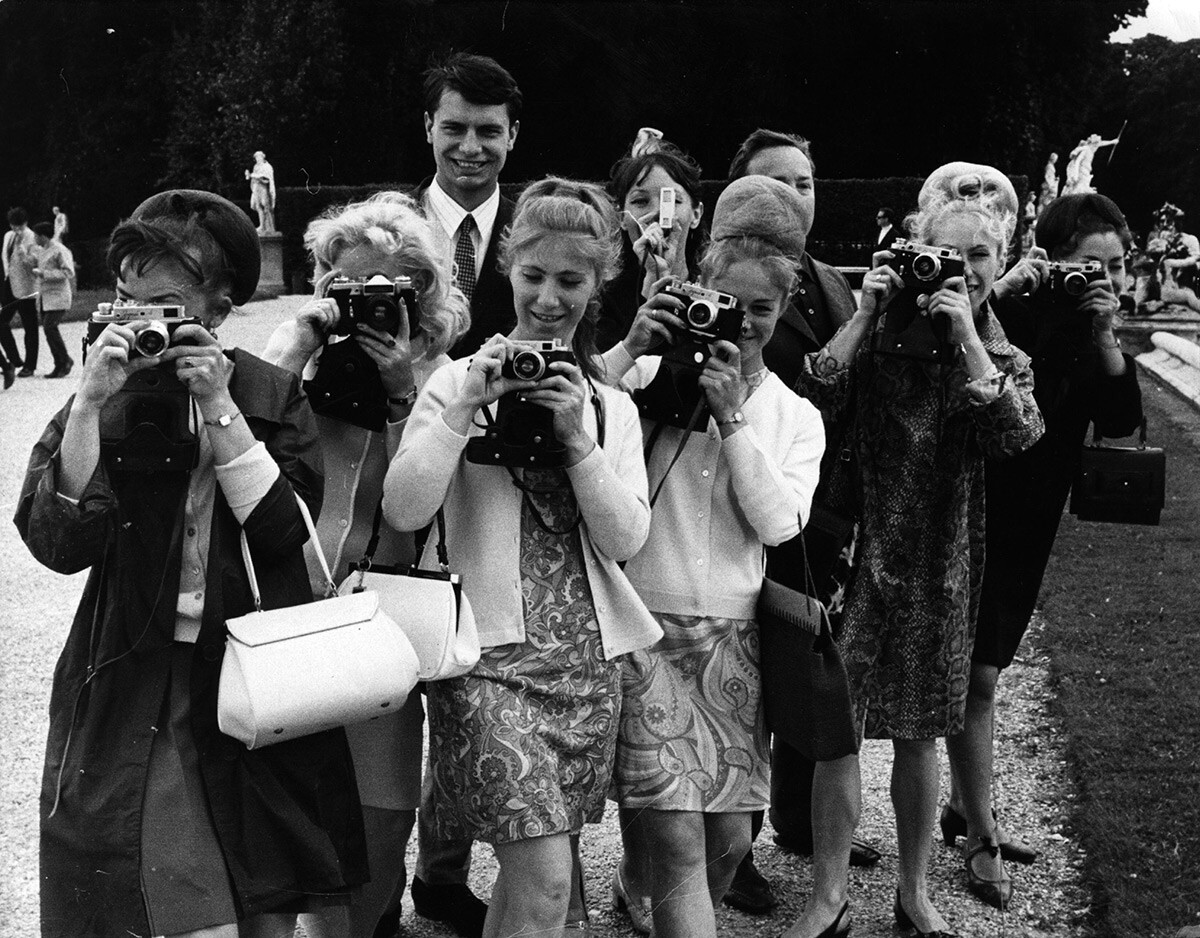 Members of the Soviet army dance troupe seen taking photographs in the park at Versailles, just outside Paris.