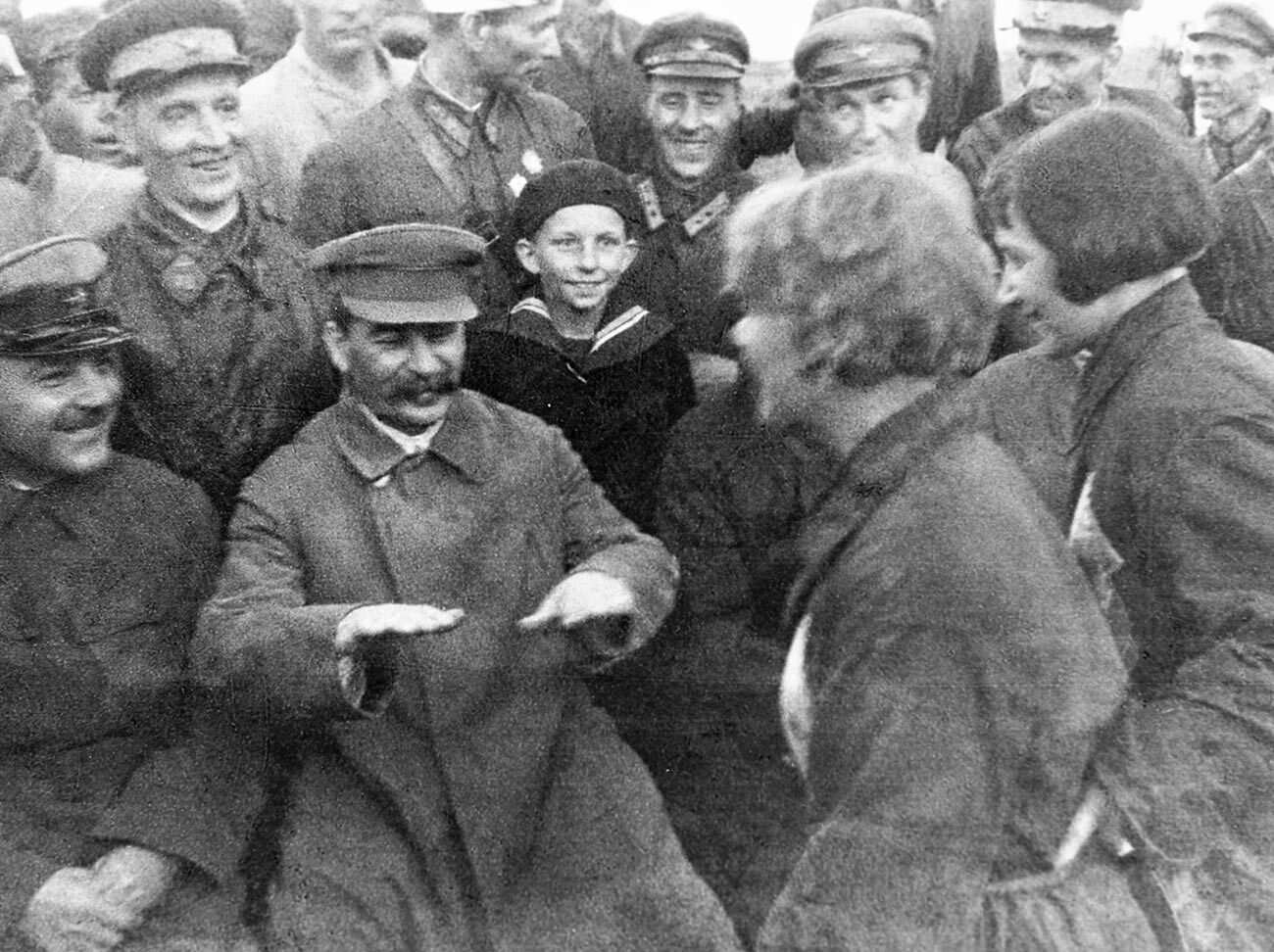 Josef Stalin (second left) and Kliment Voroshilov (left) talking with pilots and paratroopers at Tushino airfield