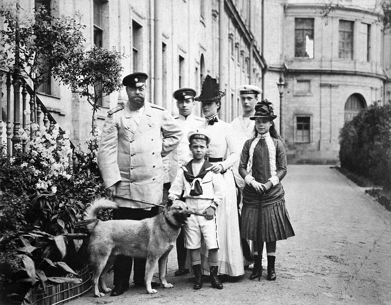 Emperor Alexander III, Tsarevitch Nicholas, Grand Duke Michael and dog, Empress Marie Feodorovna, Grand Duke George and Grand Duchess Xenia. Taken outside the Imperial palace at Gatchina