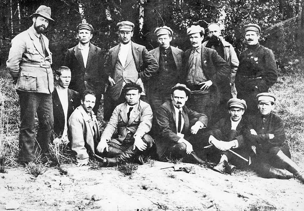 The firing squad was led by Yakov Yurovsky, commandant of Ipatiev House. Shytov tells that during his research for the book what caught his eye most were the notes of regicide Yurovsky. One of the memos contained a secret transcript of a Bolshevik meeting in 1934 at the Romanovs’ dwelling place in the Urals. /  Group of Ural Bolsheviks at the Romanovs’ “grave” — the alleged burial place of the Romanovs.