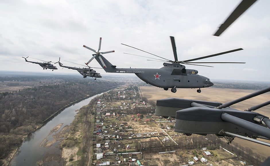 Mil Mi-26 and Mi-8 helicopters fly over the Moscow Region during a dress rehearsal of the May 9 Victory Day military parade.