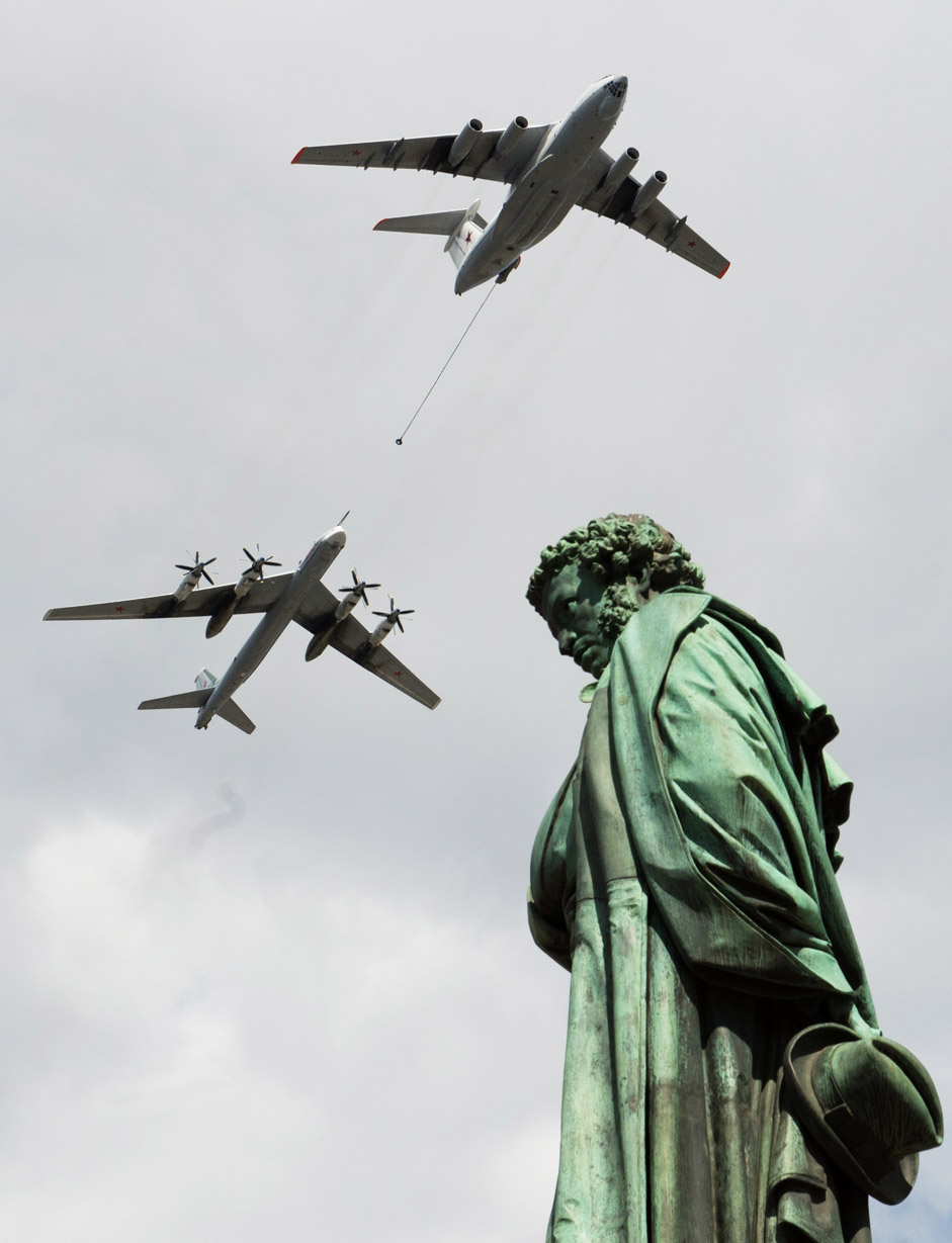 Ilyushin Il 78 and Tupolev Tu 95 planes fly over a statue of Russian poet Alexander Pushkin in Moscow during a rehearsal of the May 9 Victory Day military parade.