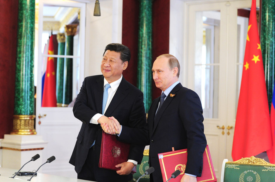 Russian President Vladimir Putin and Chinese President Xi Jinping sign joint documents following Russian-Chinese talks in the Kremlin, on May 8.