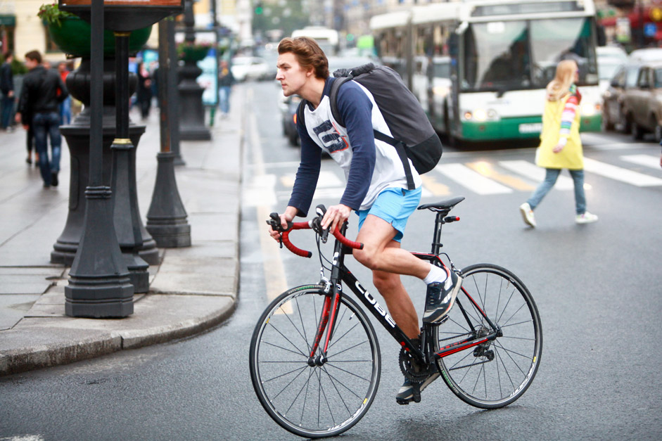 A young man riding a bicycle on Bike to Work Day