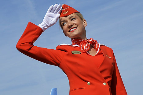 A member of Cabin crew of the Russian airline Aeroflot salutes to visitors. Source: AFP / East News