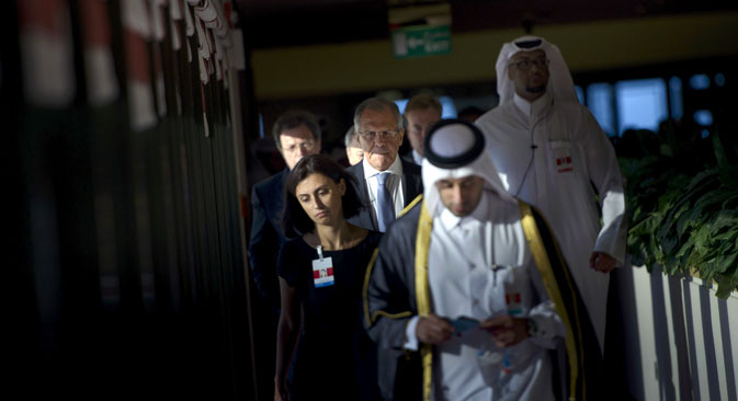 Russia's Foreign Minister Sergey Lavrov (C) walks with others before a trilateral meeting in Doha, Qatar
