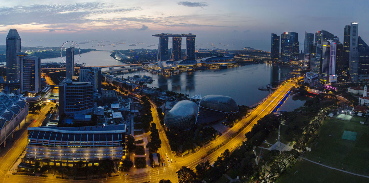 Night panorama of the Marina Bay. This district is a modern symbol of Singapore. It was built in the beginning of the 21st century on reclaimed land.
