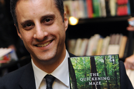 Man Booker Prize for Fiction 2009 shortlisted author Adam Foulds poses with a copy of his book 'The Quickening Maze'