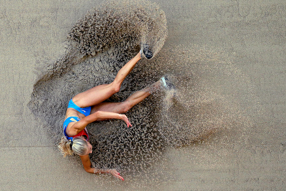 Russia's Darya Klishina lands in the pit during the women's long jump qualification at the World Athletics Championships at the Bird's Nest stadium in Beijing, Thursday, Aug. 27, 2015.