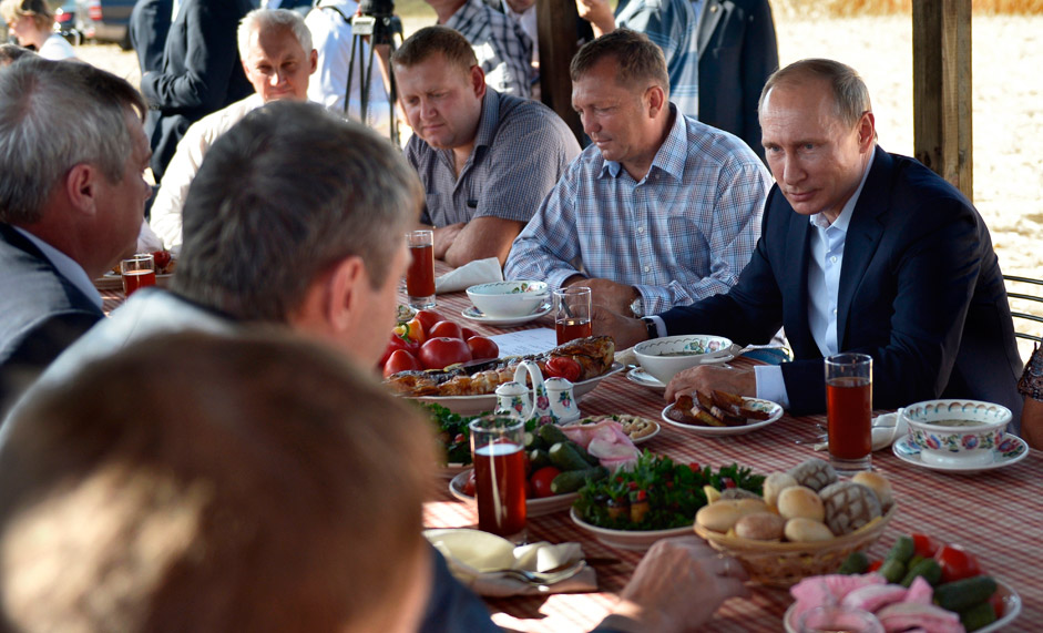 Russian President Vladimir Putin meets farmers in the village of Shaminka in Russia's Rostov Region on Sept. 24, 2015