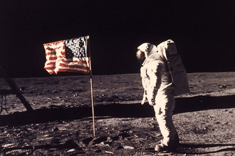 In this July 20, 1969 file photo, astronaut Edwin E. "Buzz" Aldrin Jr. stands next to a U.S. flag planted on the moon during the Apollo 11 mission.