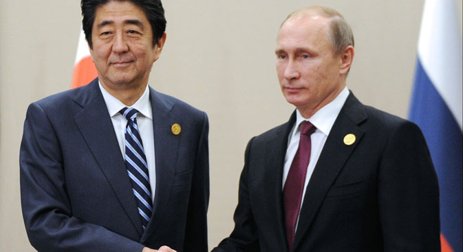 Japanese Prime Minister Shinzo Abe, left, shakes hands with Russian President Vladimir Putin prior to their talks during the G-20 Summit in Antalya, Turkey, Monday, Nov. 16, 2015.