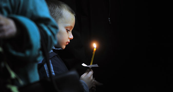 A boy at a funeral service for a victim of the A321 crash, at a church in Veliky Novgorod. Some of the victims have yet to be identified and buried. 
