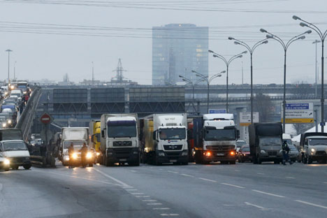 A road police officer blocks off the traffic on the Moscow Ring Automobile Road (MKAD) on the suburbs of Moscow, Russia, December 4, 20