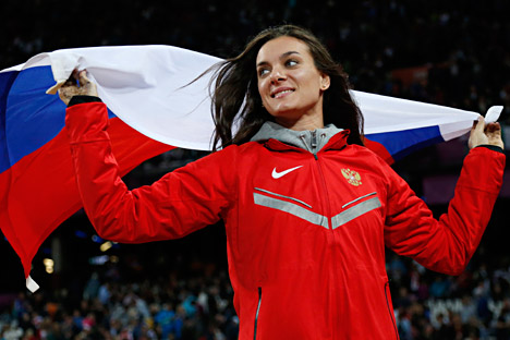 Russia's Yelena Isinbayeva celebrates winning bronze in the women's pole vault final during the athletics in the Olympic Stadium at the 2012 Summer Olympics, London, Monday, Aug. 6, 2012