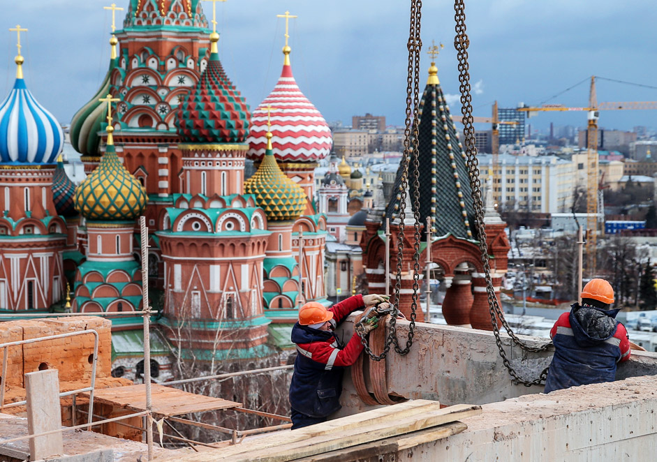 Workers seen during a demolition of a building nearby the Moscow Kremlin.