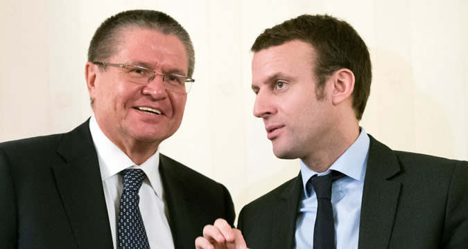 Russian Economics Minister Alexei Ulyukayev, left, and French Economics Minister Emmanuel Macron talk during the Russian-French Council of Economic, Financial, Industrial and Trade Issues session in Moscow, Russia, Monday, Jan. 25, 2016. 