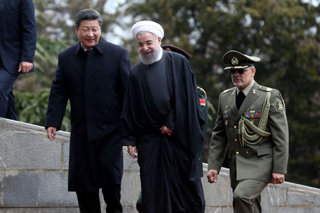 Chinese President Xi Jinping, left, is welcomed by Iranian President Hassan Rouhani during his official arrival ceremony at the Saadabad Palace in Tehran, Iran.