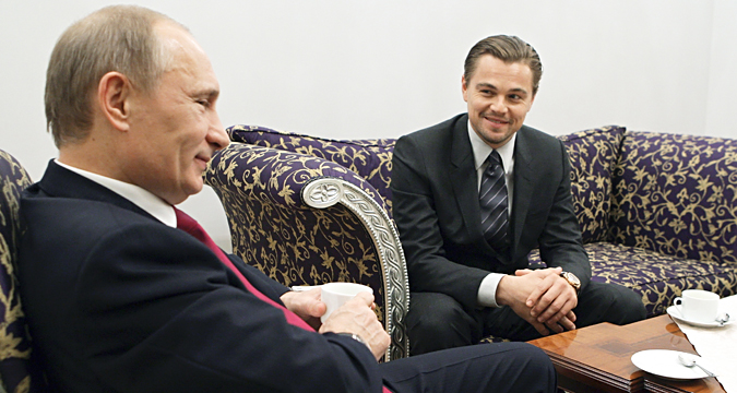 Russia's Prime Minister Vladimir Putin listens to actor Leonardo DiCaprio during their meeting, dedicated to International Tiger Forum, in St. Petersburg, November 23, 2010.