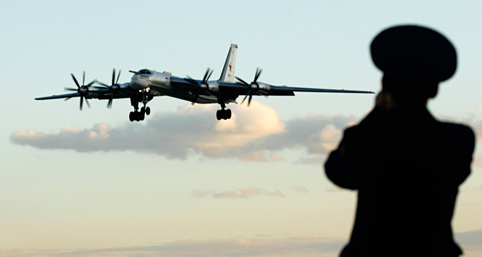 A Russian officer takes a picture of a TU-95 bomber, or Bear, at a military airbase in Engels some 900 km (559 miles) south of Moscow August 7, 2008. 